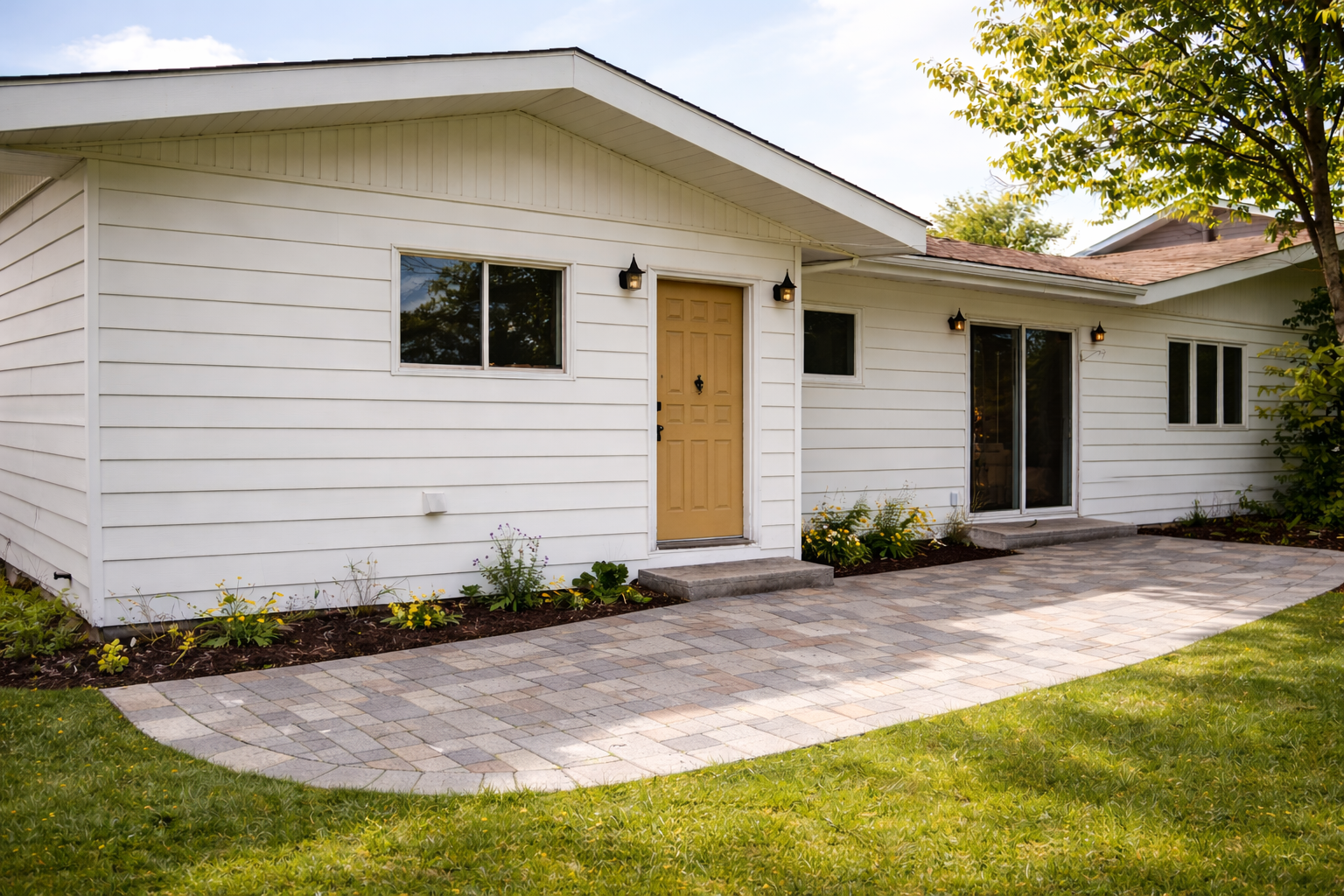 House after paver patio and landscaping